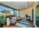 Screened patio with wicker furniture and view of yard at 2820 Highlands Blvd # A, Palm Harbor, FL 34684