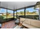 Cozy screened patio with wicker furniture and tile flooring at 2820 Highlands Blvd # A, Palm Harbor, FL 34684