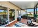 Screened patio with wicker furniture and view of yard at 2820 Highlands Blvd # A, Palm Harbor, FL 34684