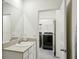 Bathroom with a single vanity and view into laundry room at 32241 Turtle Grace Loop, Wesley Chapel, FL 33545