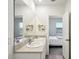 Double vanity bathroom with a view into bedroom at 32241 Turtle Grace Loop, Wesley Chapel, FL 33545