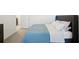 Main bedroom with gray headboard and blue bedding at 32241 Turtle Grace Loop, Wesley Chapel, FL 33545