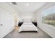 Bedroom with queen-size bed and ensuite bathroom at 32241 Turtle Grace Loop, Wesley Chapel, FL 33545