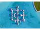 Aerial view of inflatable waterpark in crystal-clear lagoon at 32241 Turtle Grace Loop, Wesley Chapel, FL 33545