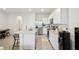 Open kitchen with granite countertops and white cabinets at 32241 Turtle Grace Loop, Wesley Chapel, FL 33545