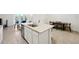 Island kitchen with granite countertops and white cabinets at 32241 Turtle Grace Loop, Wesley Chapel, FL 33545
