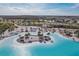 Expansive lagoon with sandy beach and numerous lounge chairs at 32241 Turtle Grace Loop, Wesley Chapel, FL 33545