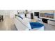 Open living room featuring a large sectional sofa, a flat-screen TV and adjacent kitchen at 32241 Turtle Grace Loop, Wesley Chapel, FL 33545