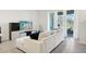 Living room with sectional sofa and sliding glass doors at 32241 Turtle Grace Loop, Wesley Chapel, FL 33545