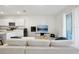 Open concept living room with sectional sofa and view of kitchen at 32241 Turtle Grace Loop, Wesley Chapel, FL 33545