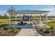 Covered picnic pavilion with tables and benches near playground at 32241 Turtle Grace Loop, Wesley Chapel, FL 33545