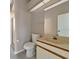 Clean bathroom with a white toilet and sink vanity, offering basic amenities at 3404 Shady Brook Ln, Sarasota, FL 34243
