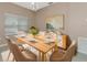 Modern dining room with a light wood table and neutral decor at 3404 Shady Brook Ln, Sarasota, FL 34243