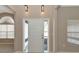 Bright entryway with a white door, neutral walls, and light fixtures at 3404 Shady Brook Ln, Sarasota, FL 34243