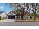 Two-story house with a dark brown garage door and mature trees in the front yard at 3404 Shady Brook Ln, Sarasota, FL 34243