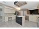 Spacious kitchen with an island and white cabinets, creating a bright atmosphere at 3404 Shady Brook Ln, Sarasota, FL 34243