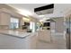 Kitchen with white cabinets, an island, and stainless steel appliances at 3404 Shady Brook Ln, Sarasota, FL 34243