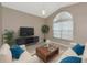 Living room with light sofas and a large TV, providing a comfortable space at 3404 Shady Brook Ln, Sarasota, FL 34243