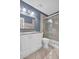 Bathroom with granite countertop, white cabinets and shower at 355 Moorings Cove Dr # 355, Tarpon Springs, FL 34689