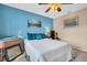 Bedroom with light blue walls and a comfortable bed at 355 Moorings Cove Dr # 355, Tarpon Springs, FL 34689