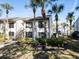 Two-story condo with exterior stairs and landscaping at 355 Moorings Cove Dr # 355, Tarpon Springs, FL 34689