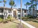 Condo building with walkway and tropical landscaping at 355 Moorings Cove Dr # 355, Tarpon Springs, FL 34689