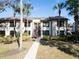 Condo building exterior with walkway, landscaping, and palm trees at 355 Moorings Cove Dr # 355, Tarpon Springs, FL 34689