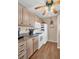 Kitchen with light wood cabinets, granite counters, and white appliances at 355 Moorings Cove Dr # 355, Tarpon Springs, FL 34689