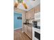 Kitchen with light wood cabinets, granite countertops, and a view into the living area at 355 Moorings Cove Dr # 355, Tarpon Springs, FL 34689