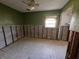 Green-walled bedroom under renovation, showing exposed walls and flooring at 4000 Huntington Ne St, St Petersburg, FL 33703