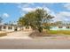 Ranch-style house with a large front yard and mature tree at 4000 Huntington Ne St, St Petersburg, FL 33703