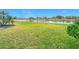 Large backyard with a grassy lawn and lake view at 5629 Maidenstone Way, Palmetto, FL 34221