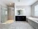 Elegant bathroom with double vanity, soaking tub, and walk-in shower at 5629 Maidenstone Way, Palmetto, FL 34221