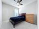 Simple bedroom with a double bed, dresser, and ceiling fan at 5629 Maidenstone Way, Palmetto, FL 34221