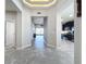 Bright and spacious entryway with tile flooring, leading to kitchen and living areas at 5629 Maidenstone Way, Palmetto, FL 34221