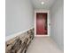 Entryway with red door and stone accent wall at 5629 Maidenstone Way, Palmetto, FL 34221