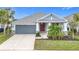 One-story home with gray siding, red door, and landscaping at 5629 Maidenstone Way, Palmetto, FL 34221