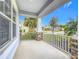 Covered front porch with white railing and stone accents at 5629 Maidenstone Way, Palmetto, FL 34221