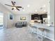 Kitchen island with granite countertop and four white stools at 5629 Maidenstone Way, Palmetto, FL 34221