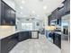 Spacious kitchen with dark cabinetry, granite counters, and stainless steel appliances at 5629 Maidenstone Way, Palmetto, FL 34221