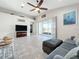 Living room with gray sofa and sliding doors leading to patio at 5629 Maidenstone Way, Palmetto, FL 34221