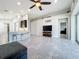 Open living room with kitchen island and view into bedroom at 5629 Maidenstone Way, Palmetto, FL 34221