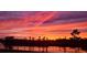 Vibrant sunset over the community's lake and landscape at 5629 Maidenstone Way, Palmetto, FL 34221