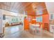 Bright dining area with an orange accent wall at 604 Pennsylvania Ave, Crystal Beach, FL 34681