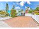Brick driveway, white fence, and nicely landscaped yard at 604 Pennsylvania Ave, Crystal Beach, FL 34681