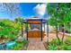 Relax in this outdoor hot tub, nestled under a gazebo in a lush tropical garden at 604 Pennsylvania Ave, Crystal Beach, FL 34681