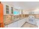 White kitchen with granite countertops and stainless steel appliances at 604 Pennsylvania Ave, Crystal Beach, FL 34681
