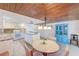 Kitchen with white cabinets, granite countertops, and a dining area at 604 Pennsylvania Ave, Crystal Beach, FL 34681