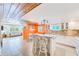 Modern white kitchen with island, granite counters, and breakfast bar at 604 Pennsylvania Ave, Crystal Beach, FL 34681
