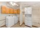 Laundry room with washer, dryer, and ample storage cabinets at 604 Pennsylvania Ave, Crystal Beach, FL 34681
